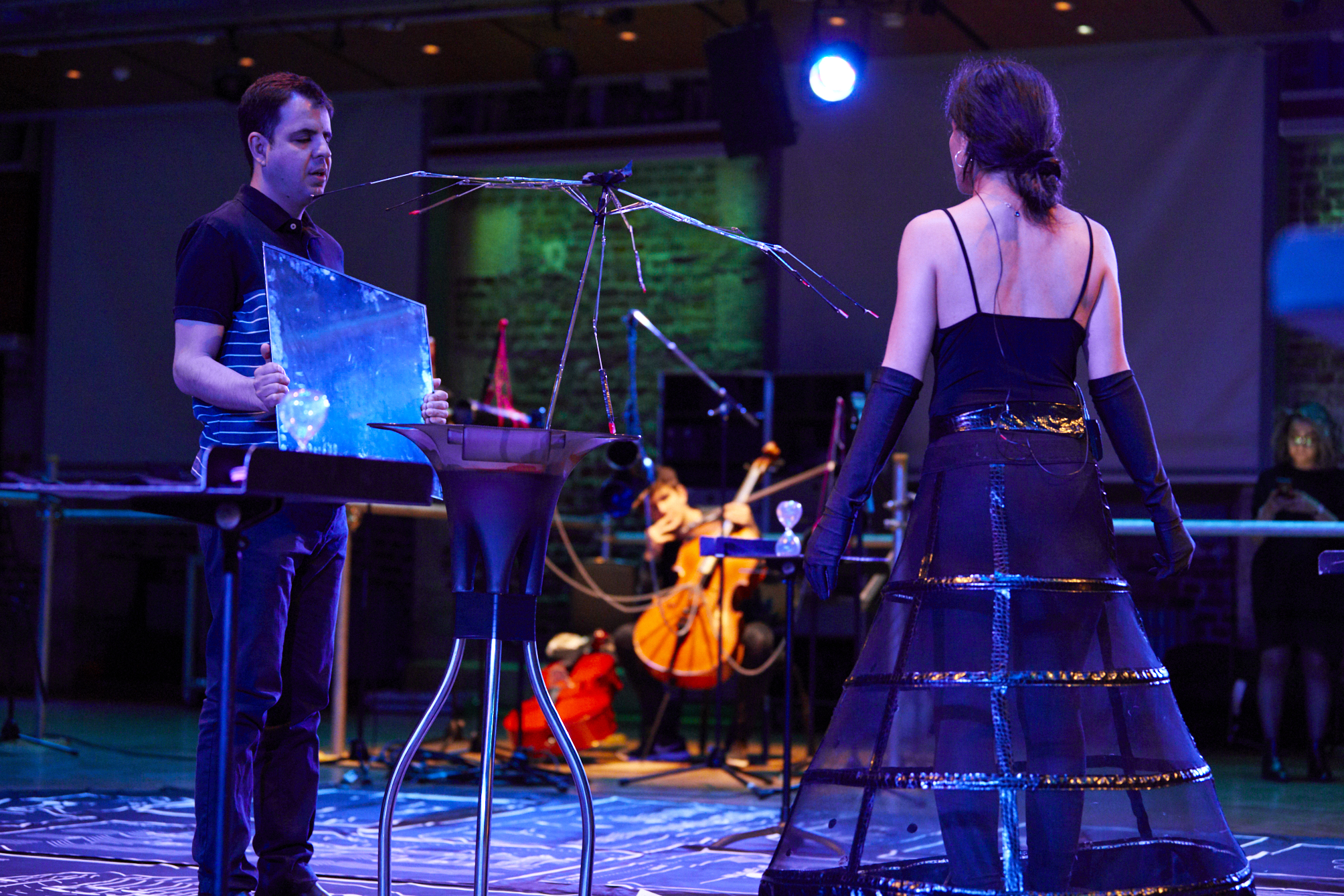 It is a photo of slider showing Davood standing while holding a mirror before a lady