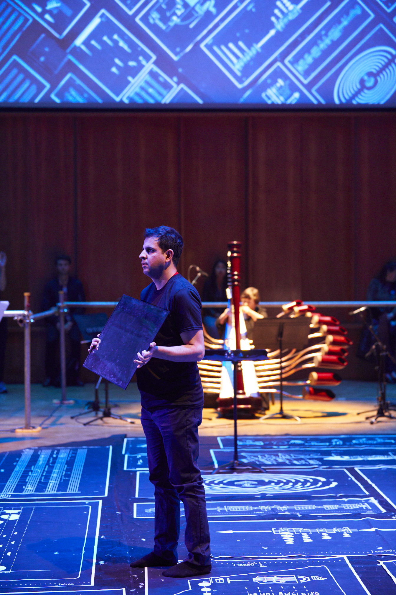 It is a photo of slider showing Davood standing while holding a mirror from another angle